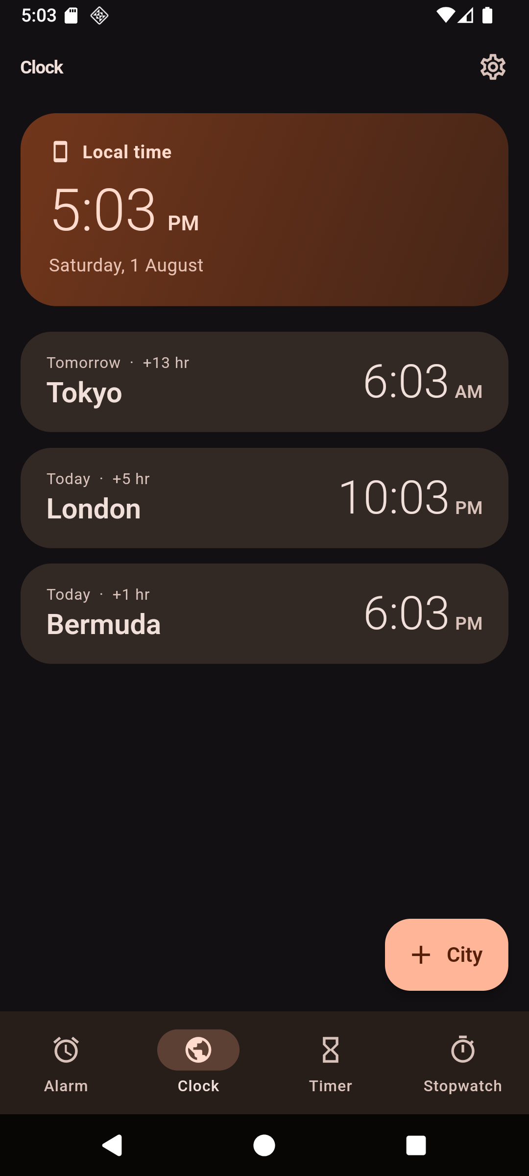 The Clock tab: a local time card reading 5:03 PM on Saturday 1 August, then pinned cities — Tokyo at 6:03 AM tomorrow, London at 10:03 PM today and Bermuda at 6:03 PM today, each with its offset.